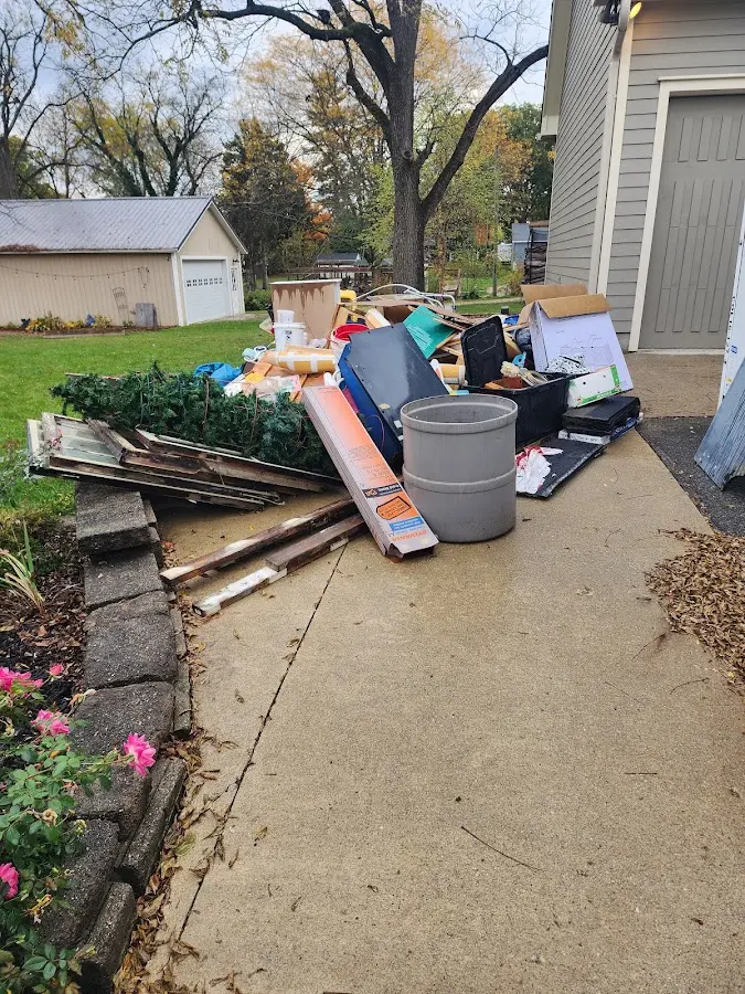 Dumpster being loaded with debris for Estate Cleanout Dumpster Rental in Channelview
